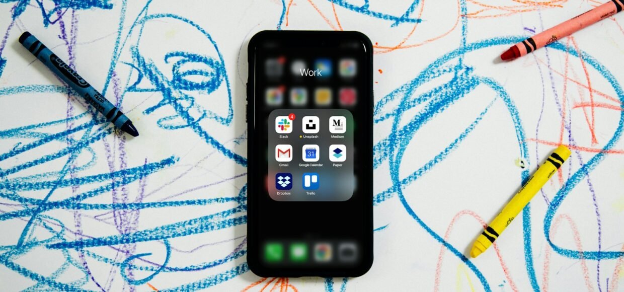 black iphone 4 on white and blue textile