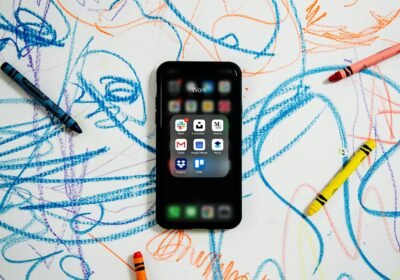 black iphone 4 on white and blue textile
