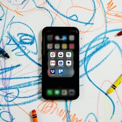 black iphone 4 on white and blue textile