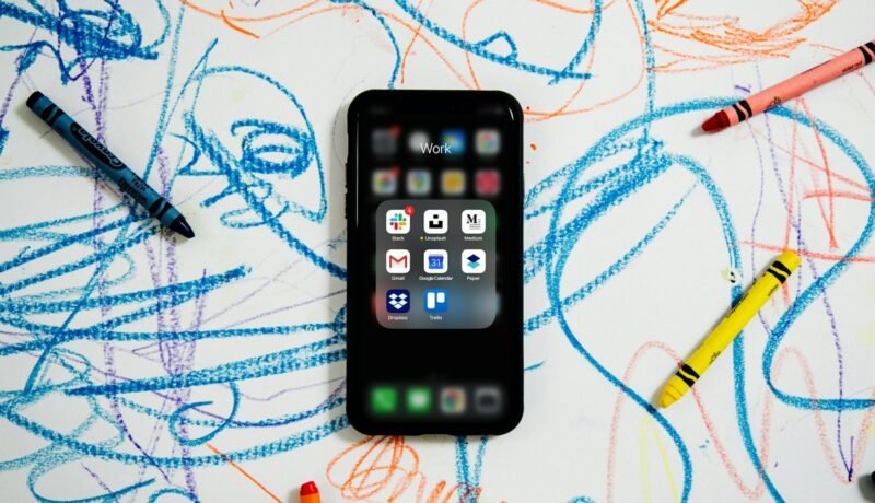 black iphone 4 on white and blue textile