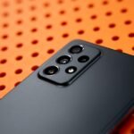 black remote control on orange and white polka dot textile