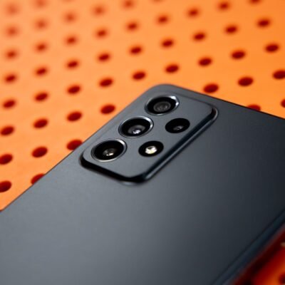 black remote control on orange and white polka dot textile